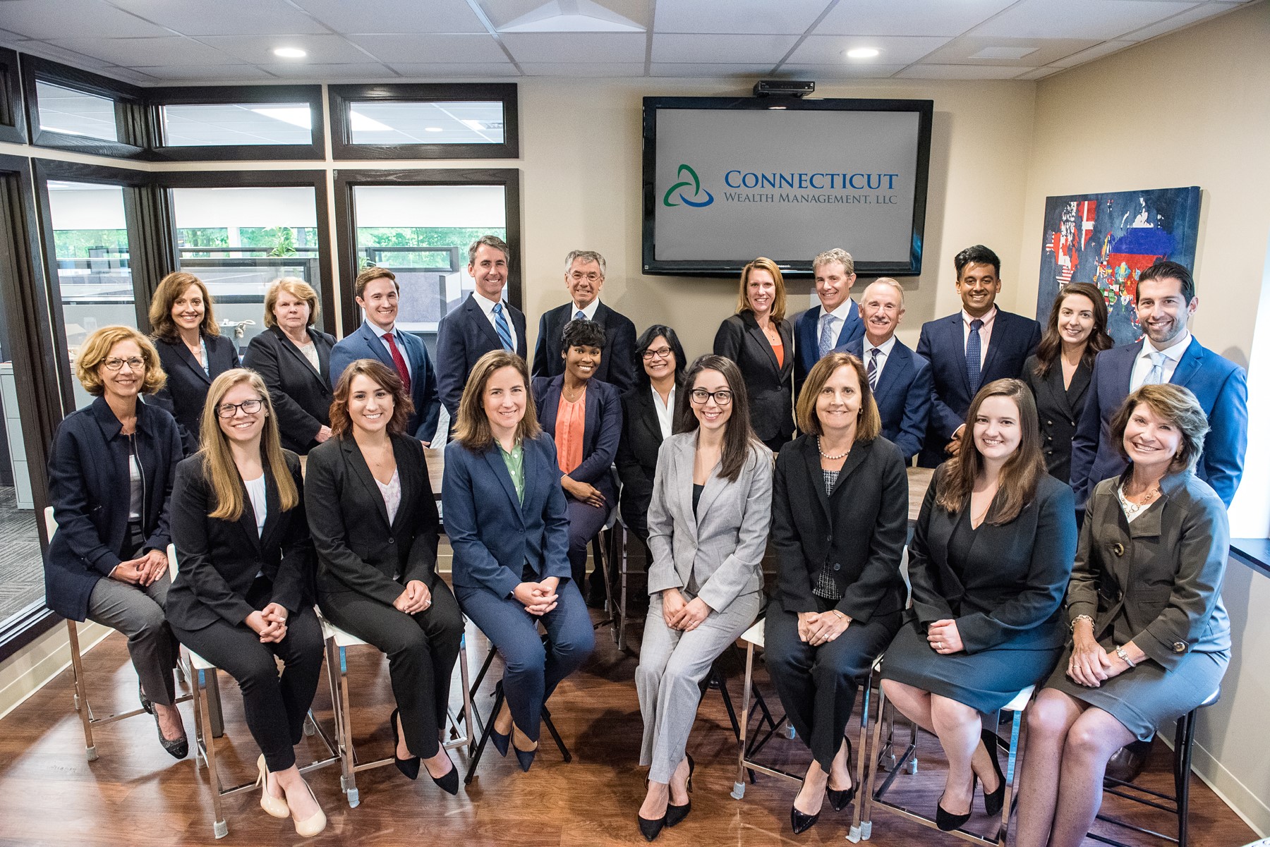 Connecticut Wealth Management team standing inside their Farmington office