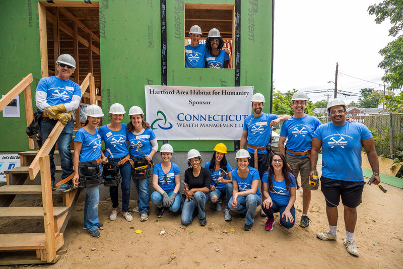 Members of Connecticut Wealth Management outside a house they built with Habitat for Humanity