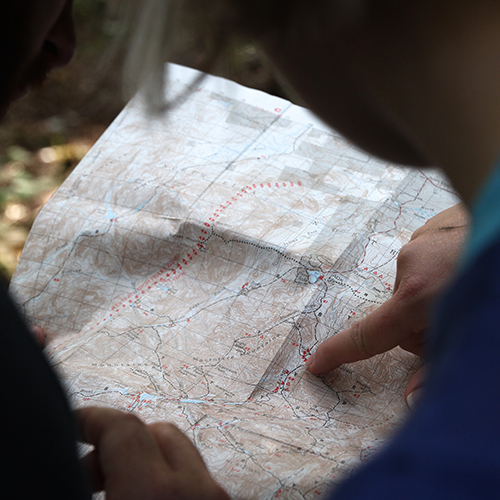 A woman pointing at a map